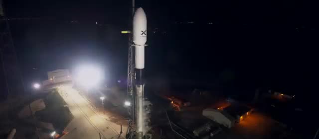 A Falcon 9 on the pad at night during a Starlink countdown