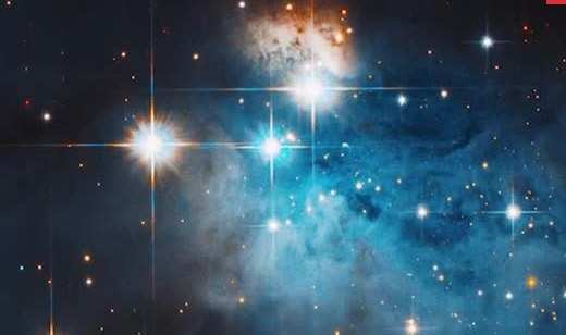 Blue star-forming nebula with bright stars and diffraction spikes