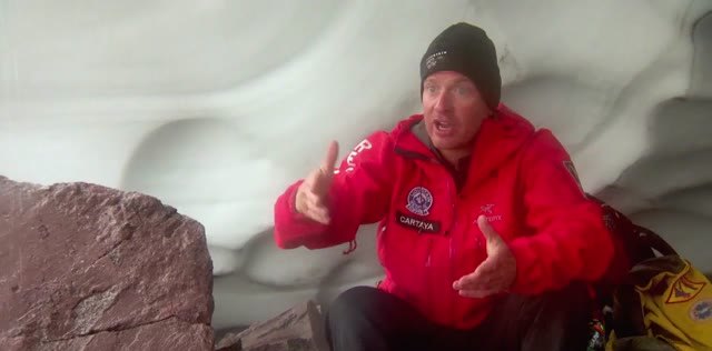 Researcher inside a blue ice cave on Mount St. Helens