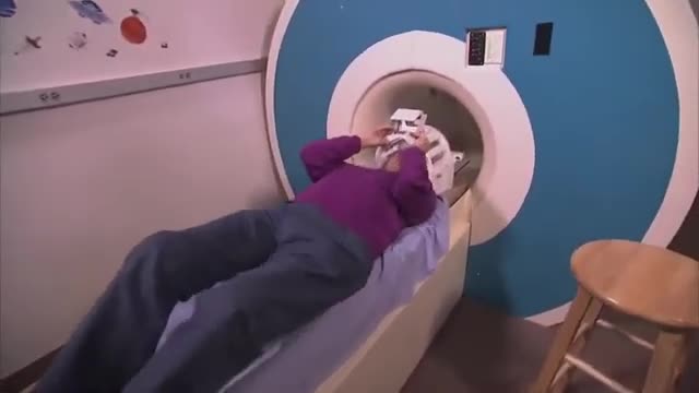 A person lying in an MRI scanner
