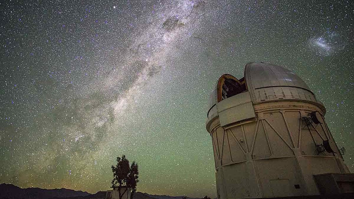Star trails and the Milky Way over an observatory