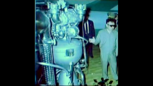 Rocket engine test stand with people in protective clothing
