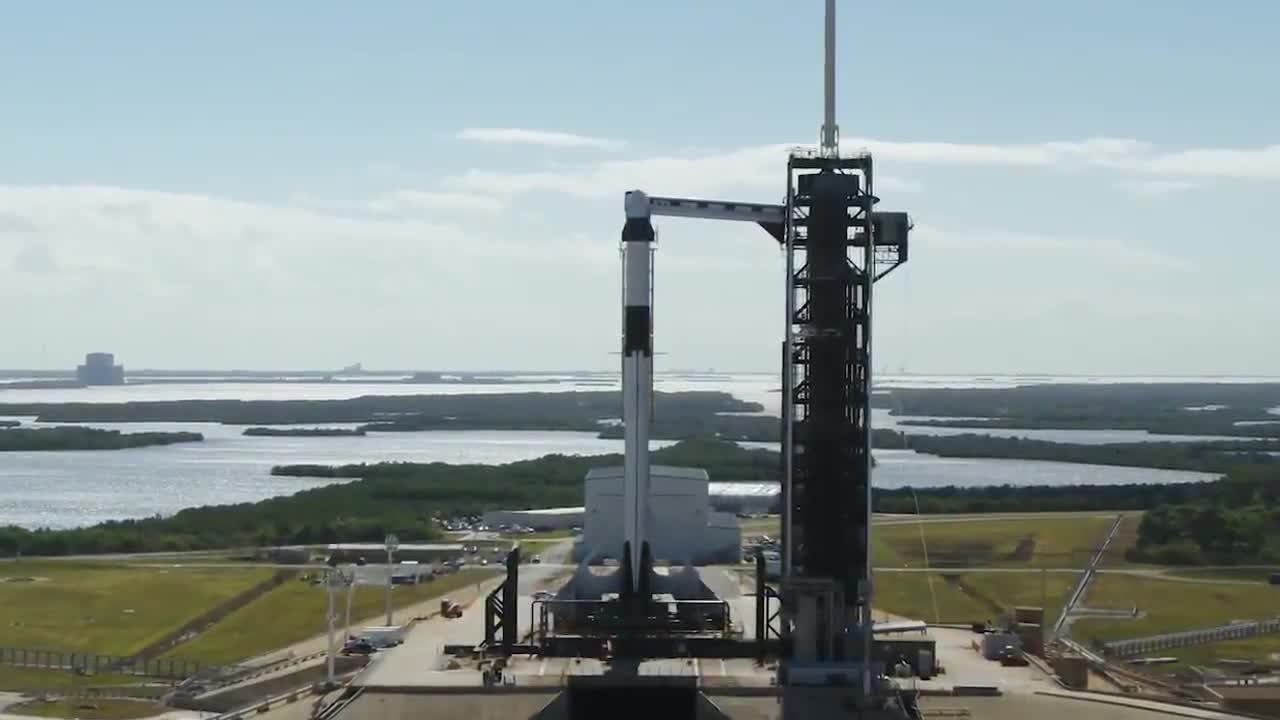 A Crew Dragon spacecraft standing on the launch pad.