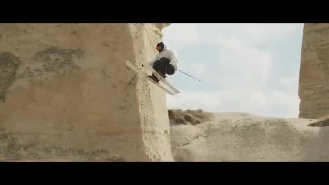A skier jumping between rock walls.
