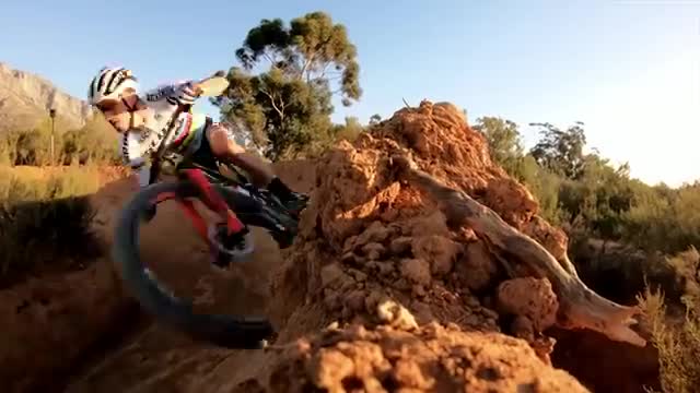 A mountain biker jumping a rocky trail.