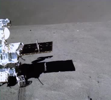 A lunar rover on the grey surface of the Moon.