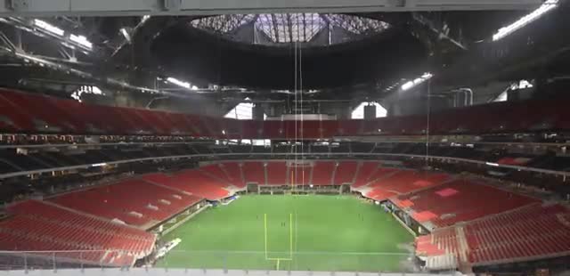 A stadium with a spiral roof opened above the field