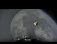 Crew Dragon, a small white capsule, just after it pulled away from Falcon 9 above the cloud deck.