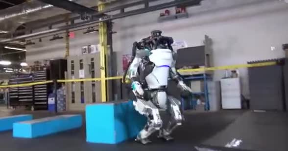 A humanoid robot stepping onto a box