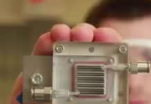 A small metal cell with a grid of fins