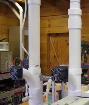 White pipes and small fans of a homemade desiccant air conditioner