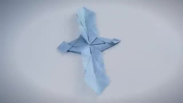 A pale blue sheet folded into a symmetric star of creases.