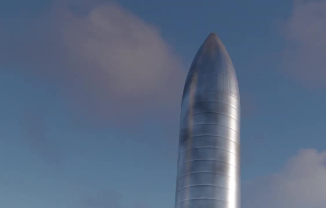 Stainless-steel Starship nose cone against a blue sky