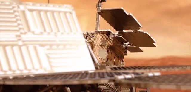 A Mars lander with open solar panels.