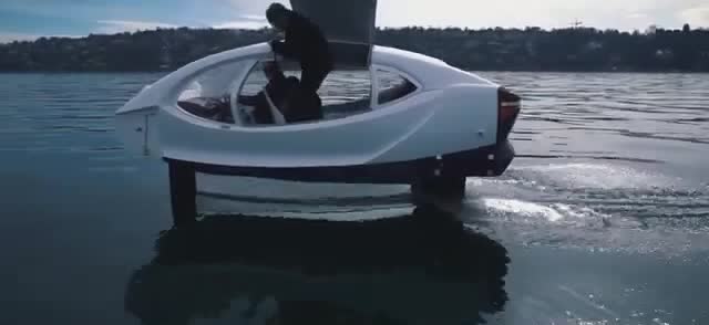 A white foiling car skimming above the water.