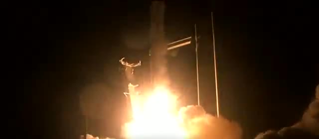 A Falcon 9 lifting off at night with Crew Dragon.