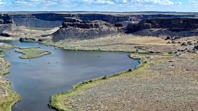 A canyon lake cut through layered rock.