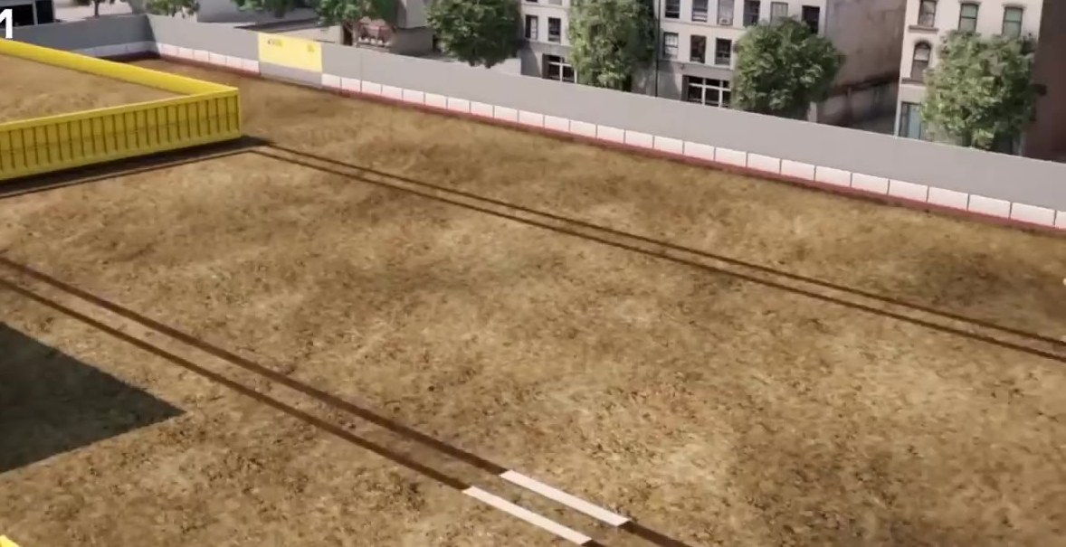 Grand Paris Express construction cut with track guides and city buildings beyond