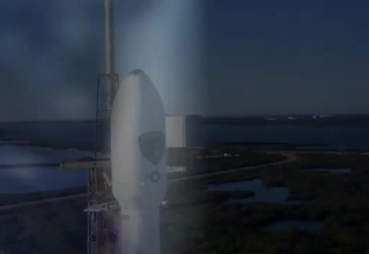 A rocket fairing on a pad at dusk.