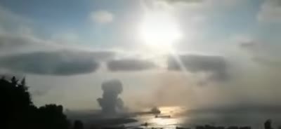 Mushroom cloud rising over the Beirut port in bright haze
