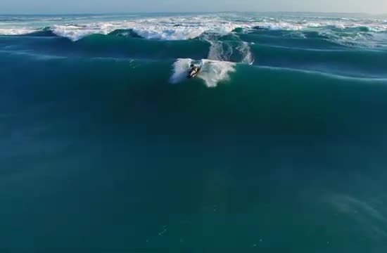 A jet ski on a steep ocean wave.