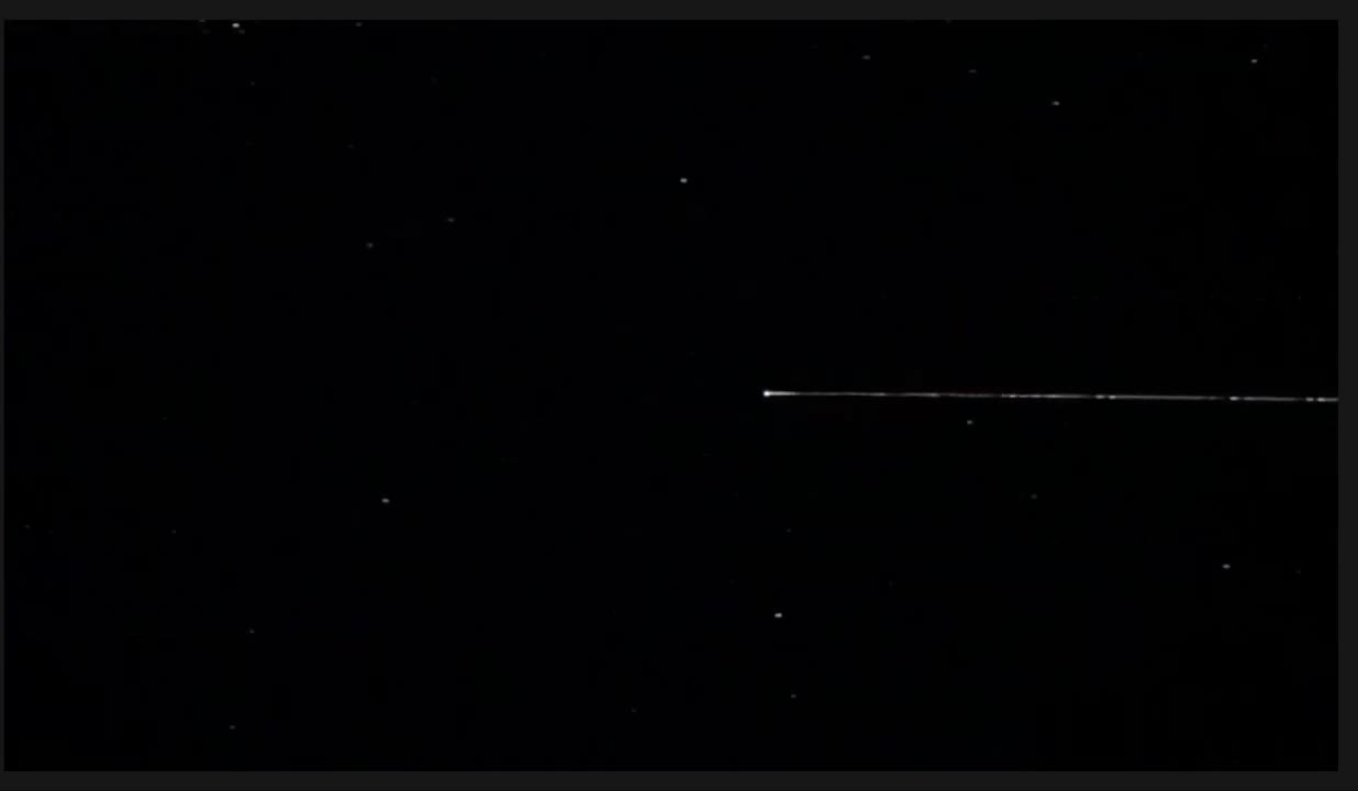 Thin bright streak of the Hayabusa2 capsule fireball against a star field