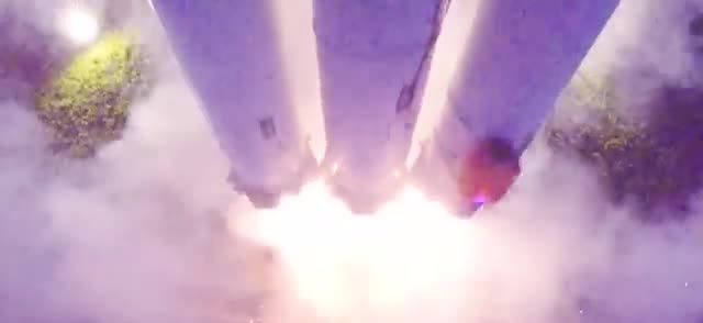 Three model rocket cores lifting off together in a cloud of exhaust