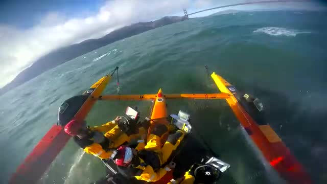 A yellow foiling boat on open water