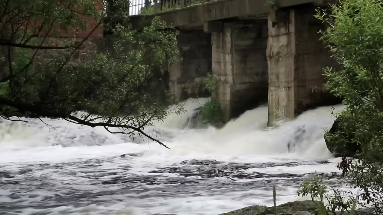 Standing wave where fast river water slows and piles up under a bridge