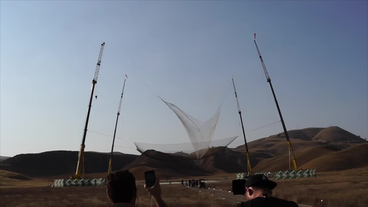 Cranes holding up the 100-by-100-foot net for Luke Aikins' jump in Simi Valley