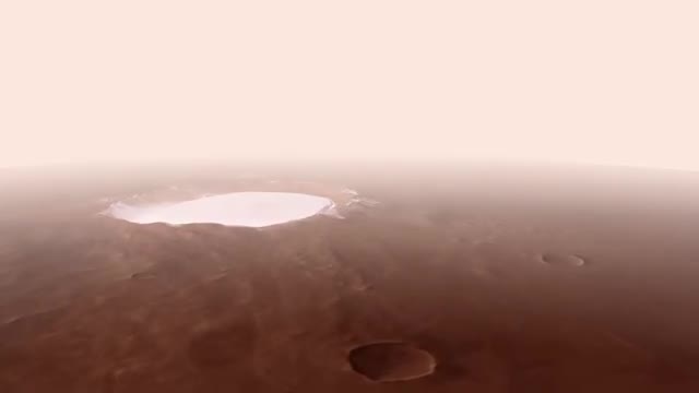 A white ice-filled crater on the rusty surface of Mars.