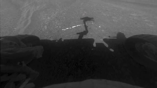 The Opportunity rover's wheel and shadow on Mars.