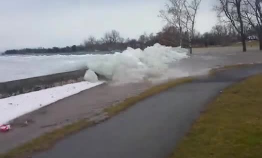 A wall of lake ice shoving onto a path beside the shore
