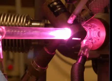 A glowing laboratory tube used in an origins-of-life experiment.