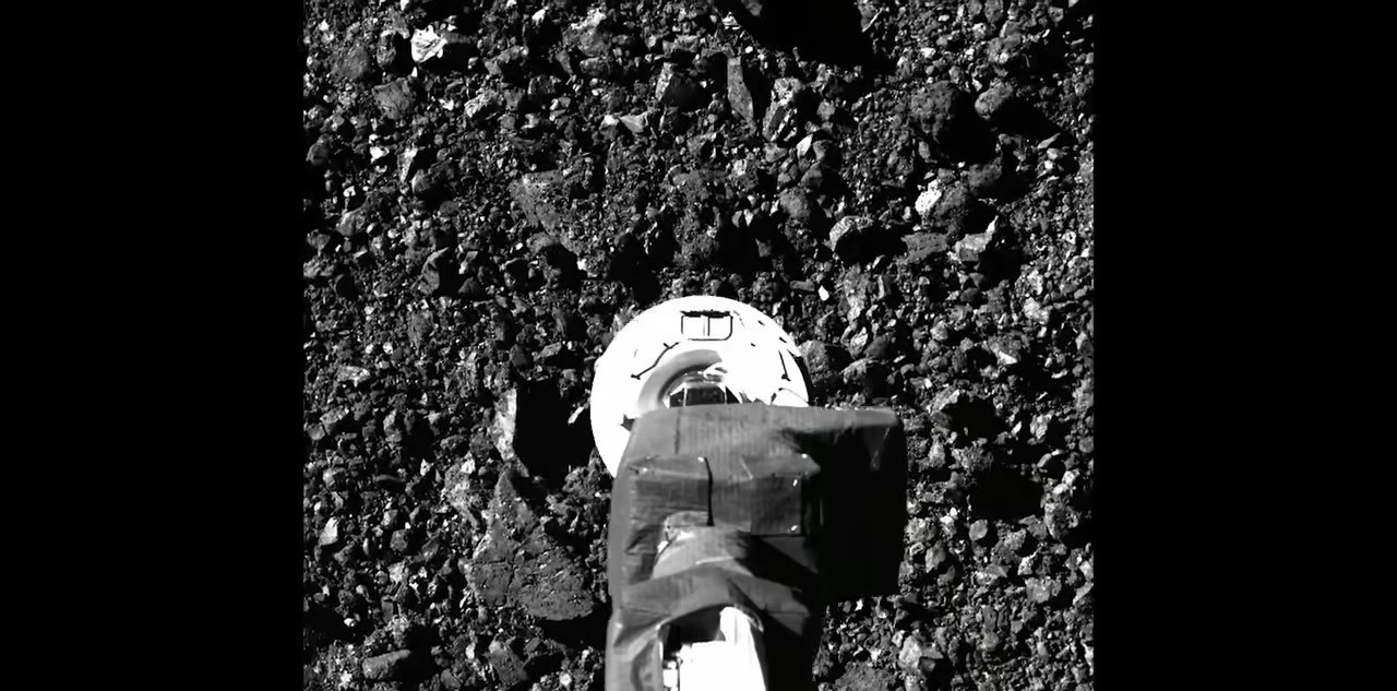 OSIRIS-REx TAGSAM head contacting Bennu’s rocky surface during sample collection