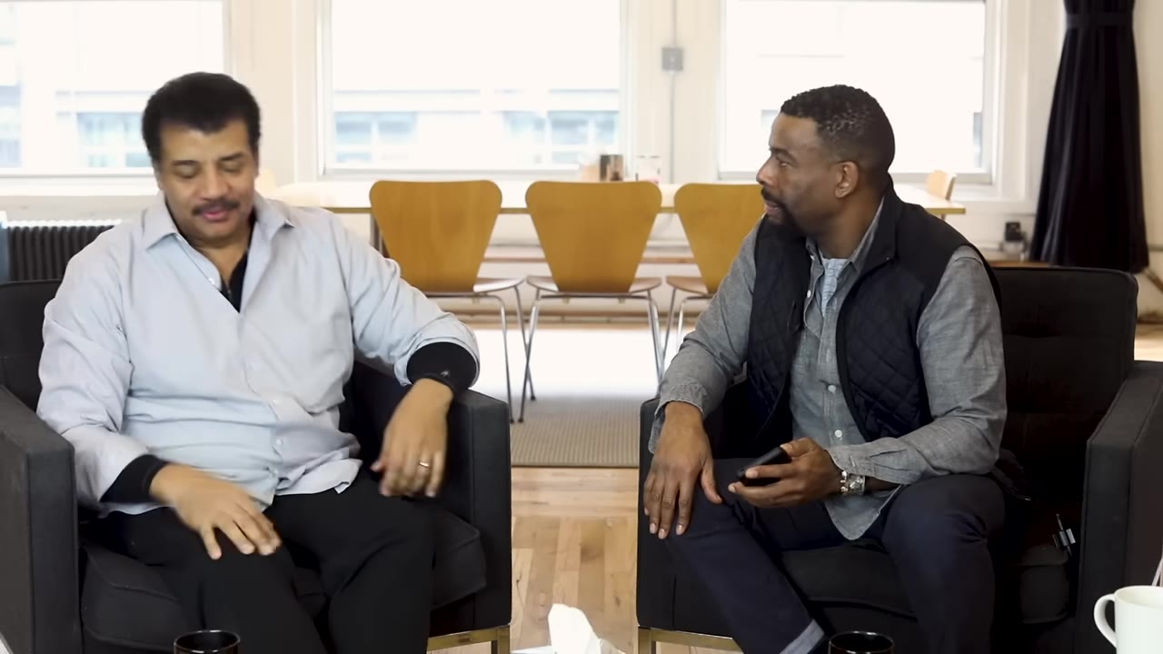 Two people seated for a conversation about how the Moon raises ocean tides