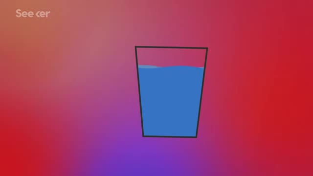 Glass of water on a red-to-blue background