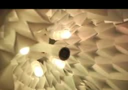 A folded paper structure lit from inside.