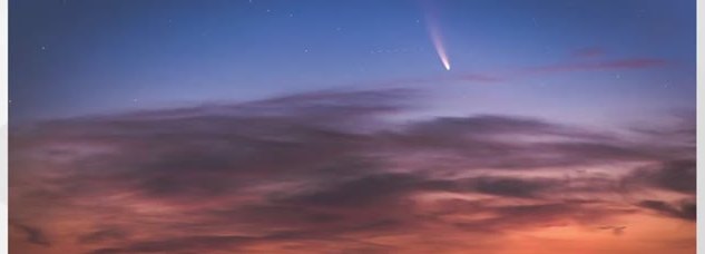 Comet NEOWISE with a bright tail above twilight clouds