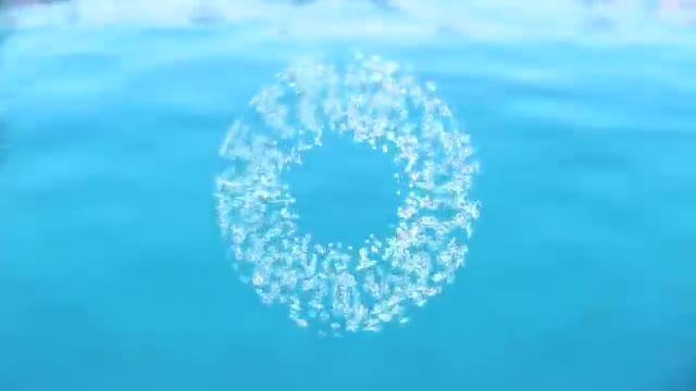 A bright ring of dye suspended in blue water