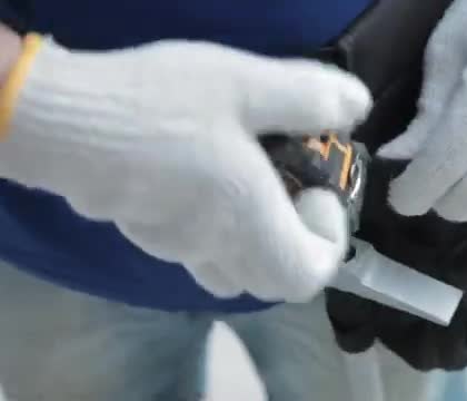 Gloved hands locking a metal pin into a black formwork panel.