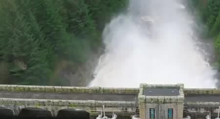 Water pouring over a dam into the reservoir below