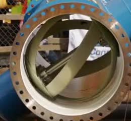 A turbine inside a blue pipe flange.
