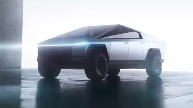 The angular stainless-steel Cybertruck on a wet stage, with a light bar across the nose.