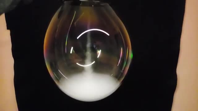 A soap bubble filled with white smoke.