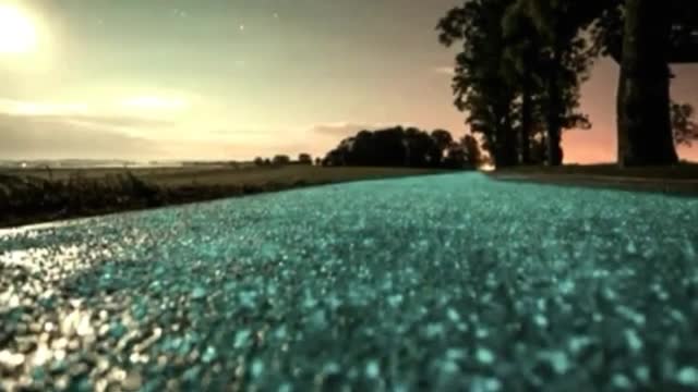A bike path glowing blue at night.