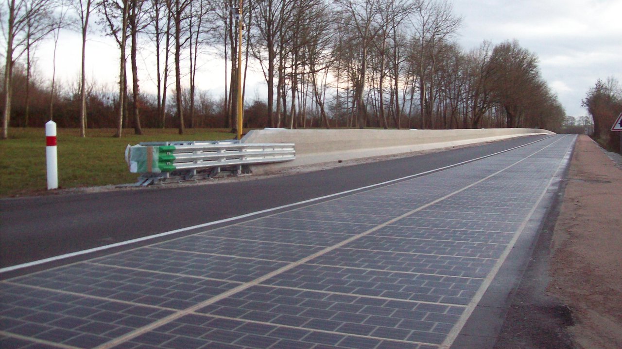 A country road in Tourouvre-au-Perche, Normandy, with one lane surfaced in dark solar panels.