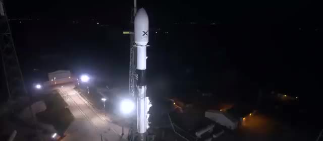 A Falcon 9 on the pad at night before a Starlink launch