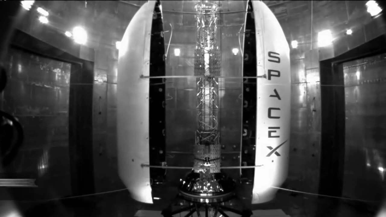 Falcon fairing halves opening around a test payload in a lab