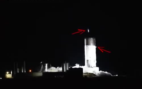 Starship test tank glowing and venting at night on the pad